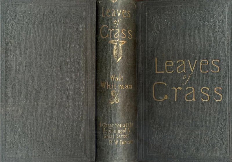 The open cover of a second edition of Leaves of Grass by Walt Whitman showing the words "I Greet You at the Beginning of A Great Career. R.W. Emerson" embossed in gold on the spine.