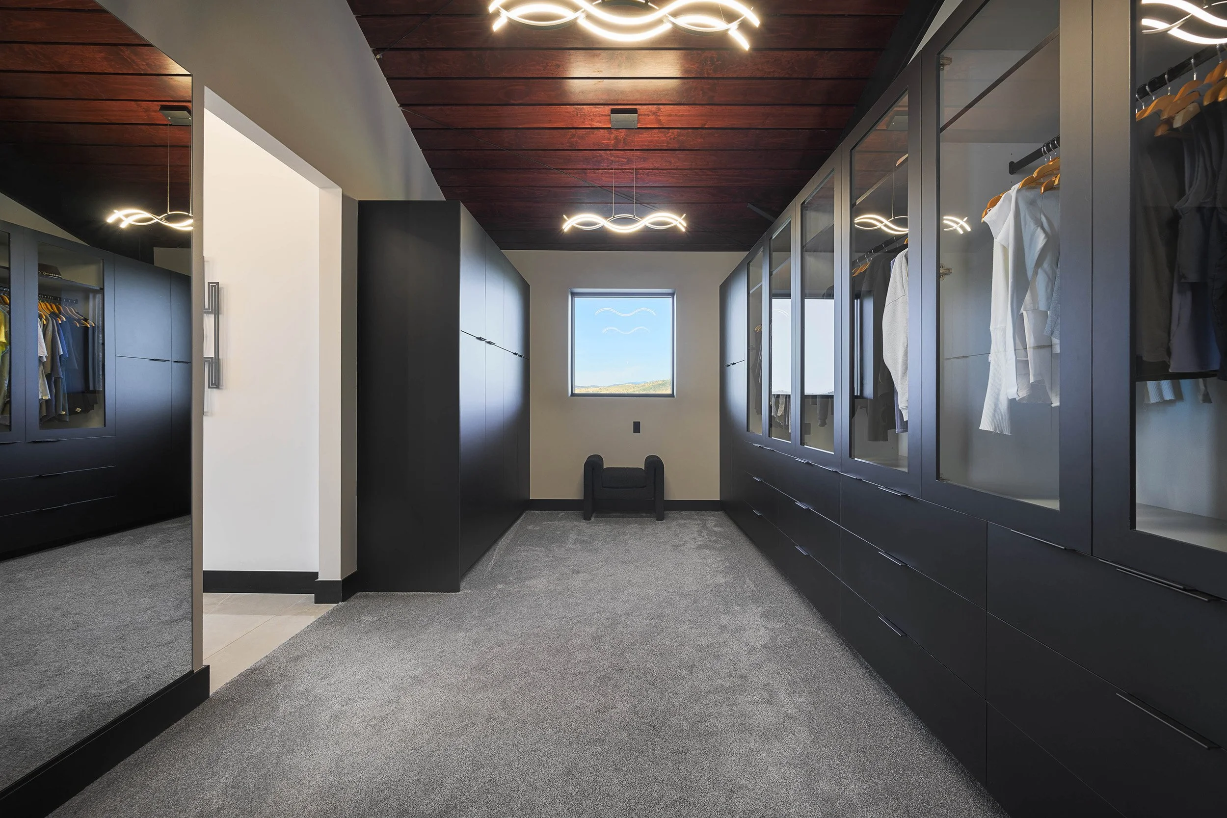 aggregate-steel-primary-closet-wood-slat-ceiling-golden-pendants.jpg