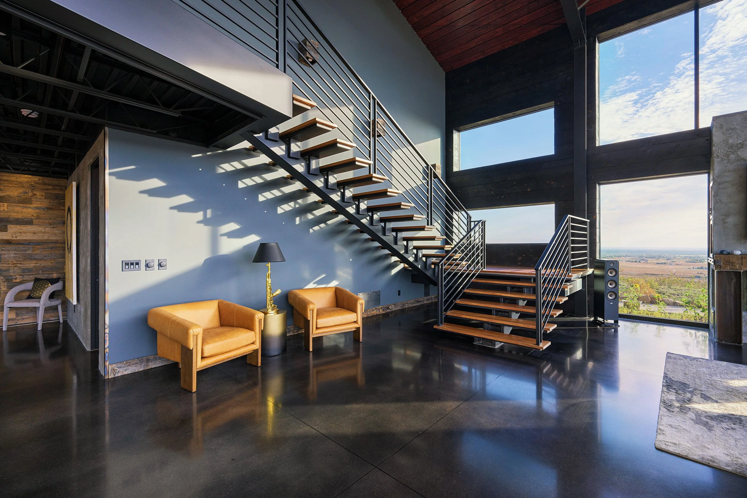 aggregate-steel-industrial-staircase-black-beam-orange-chairs.jpg