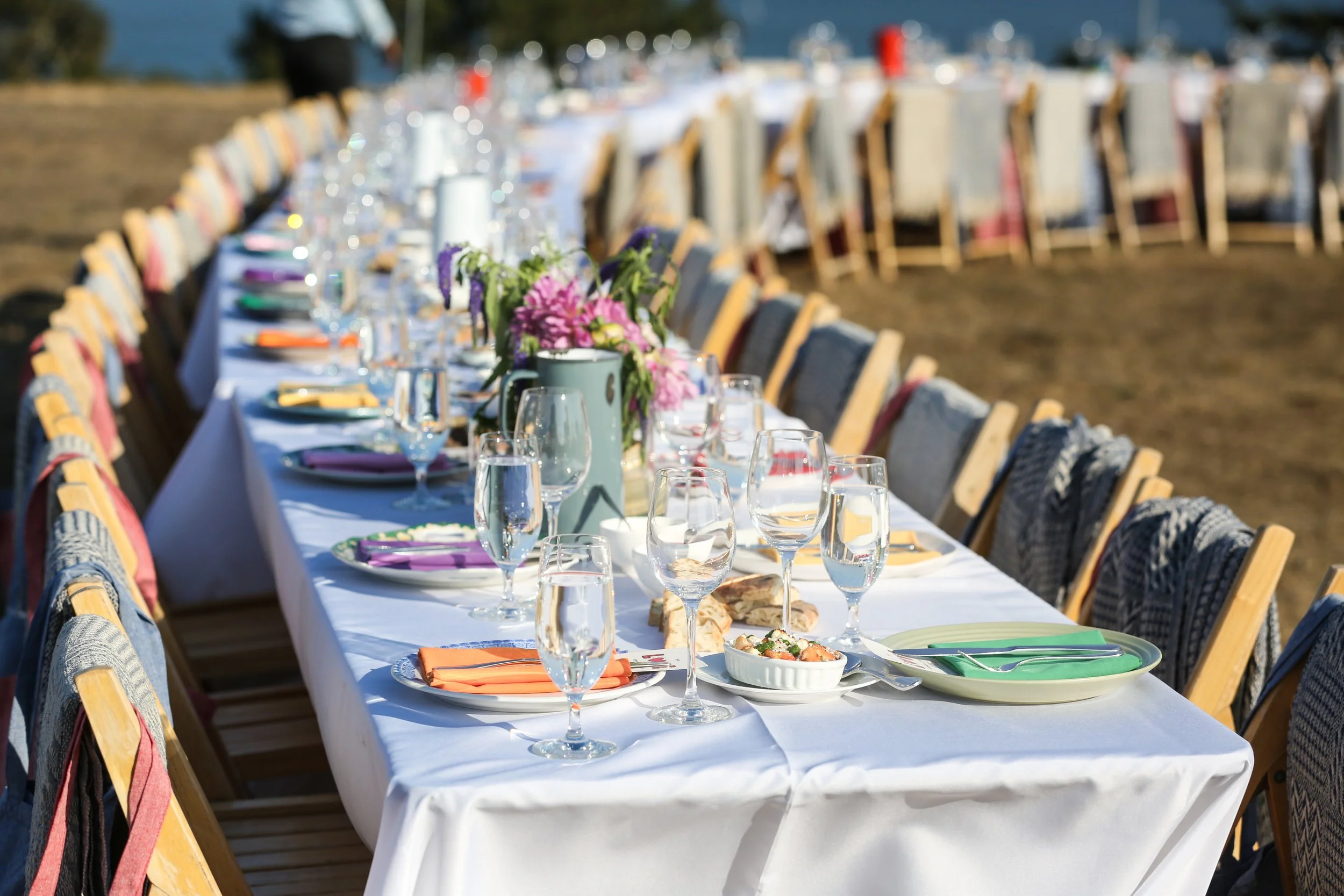 Elegant long-table setting with floral centerpieces for full-service bespoke catering in San Diego