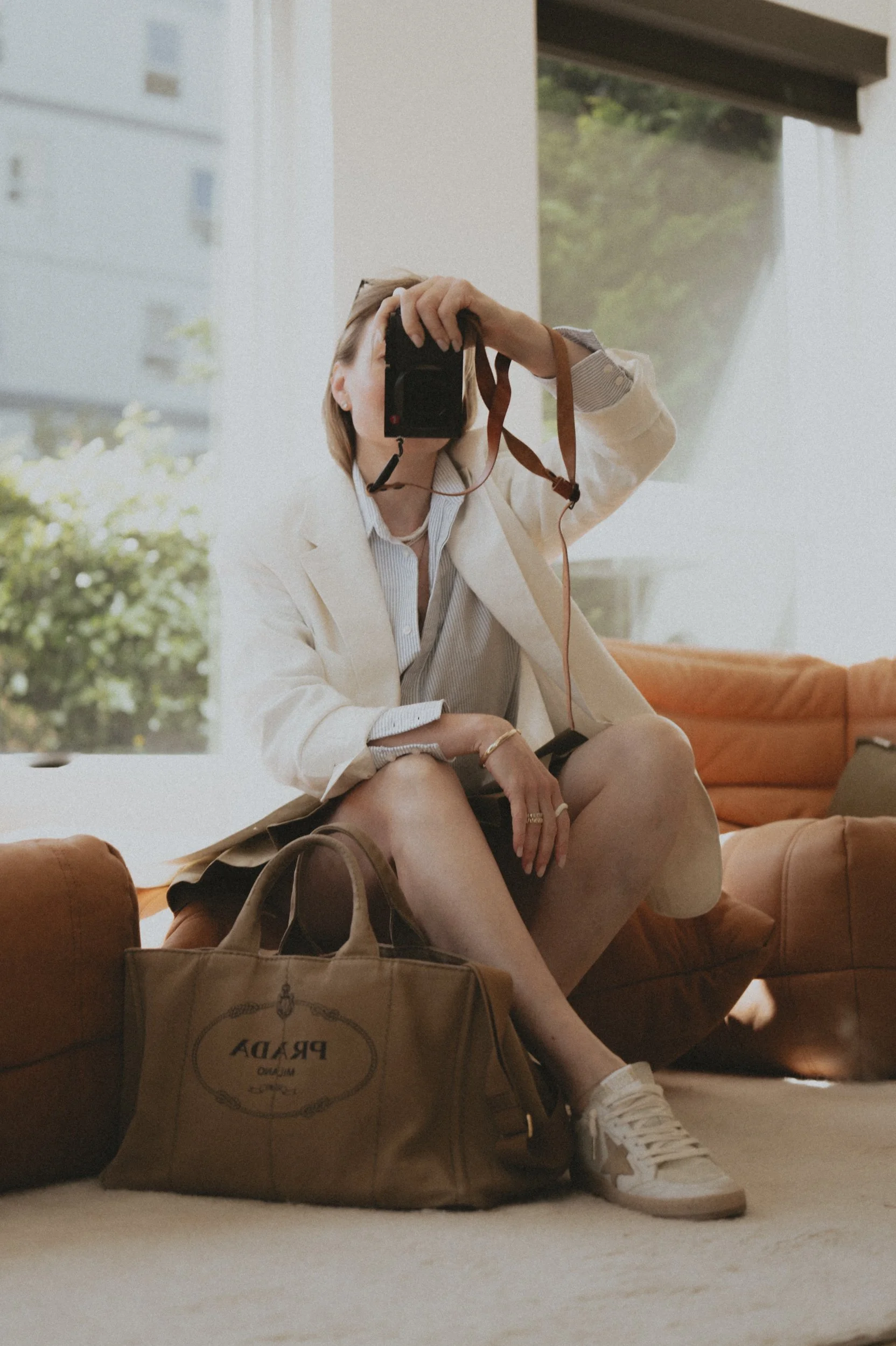 Buck Mason white linen blazer 7 for all mankind mini skirt golden goose ball Star sneakers Prada Canapa bag golden goose journey Oxford shirt  
