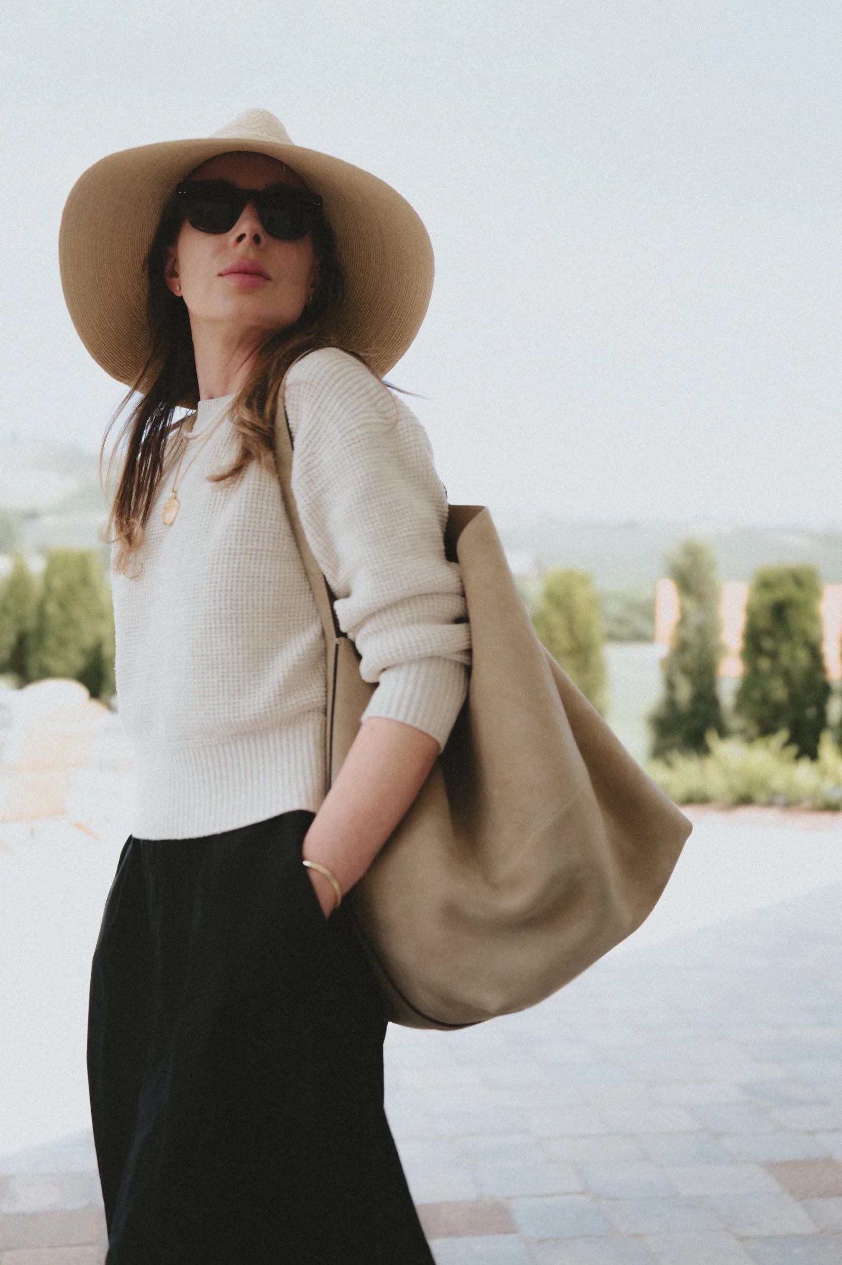 Janessa Leone Colette straw hat buck mason cotton dress buck mason cotton shrunken crew neck sweater toteme belted tote in suede