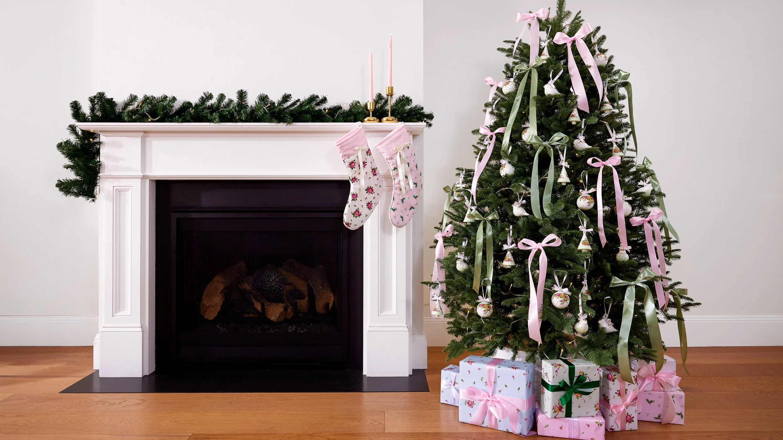 Royal Albert. A Christmas tree next to a fireplace with presence beneath it..
