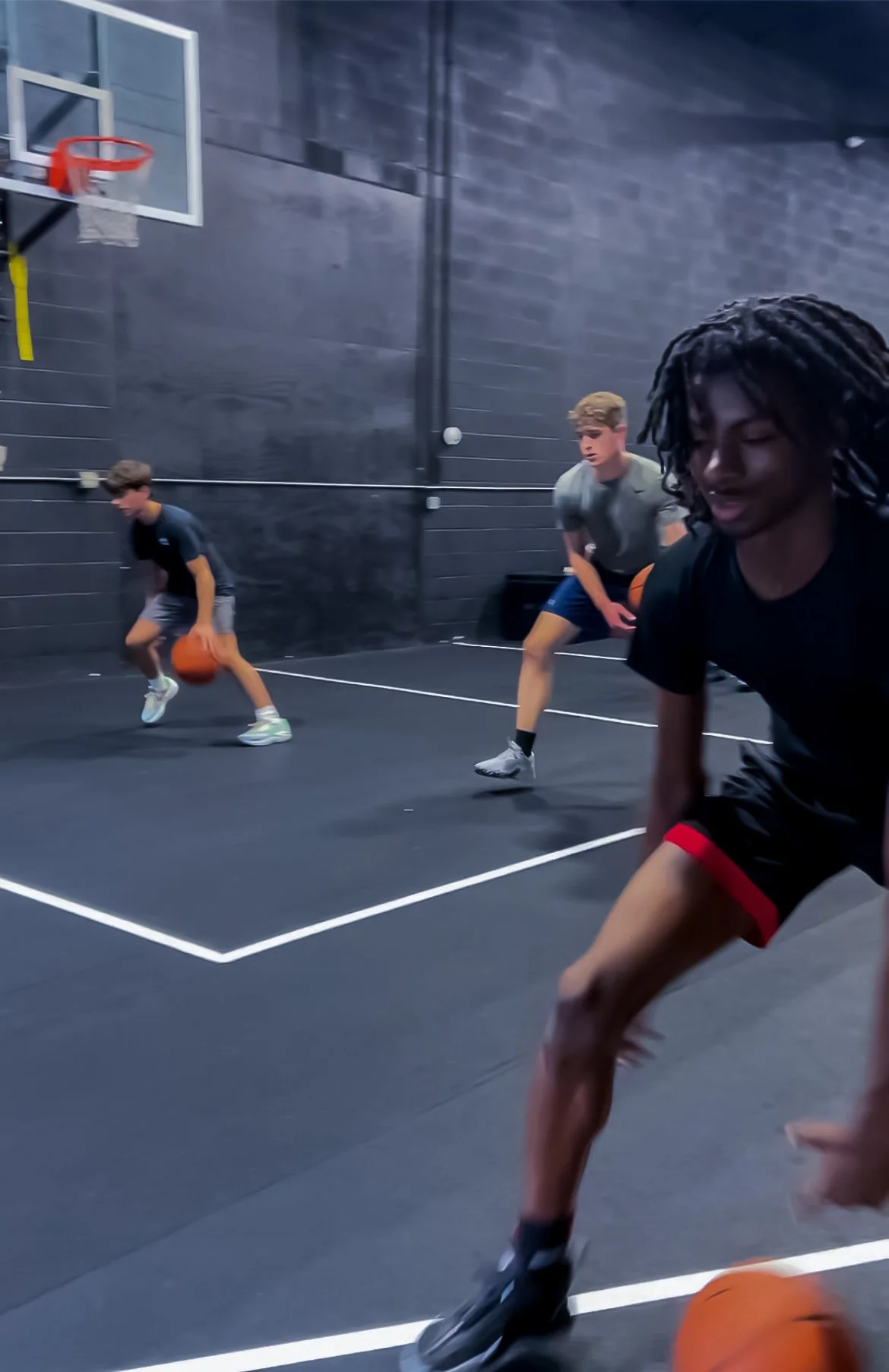 A Team Finesse guard attacking off the dribble in the Finesse Hoops Training gym