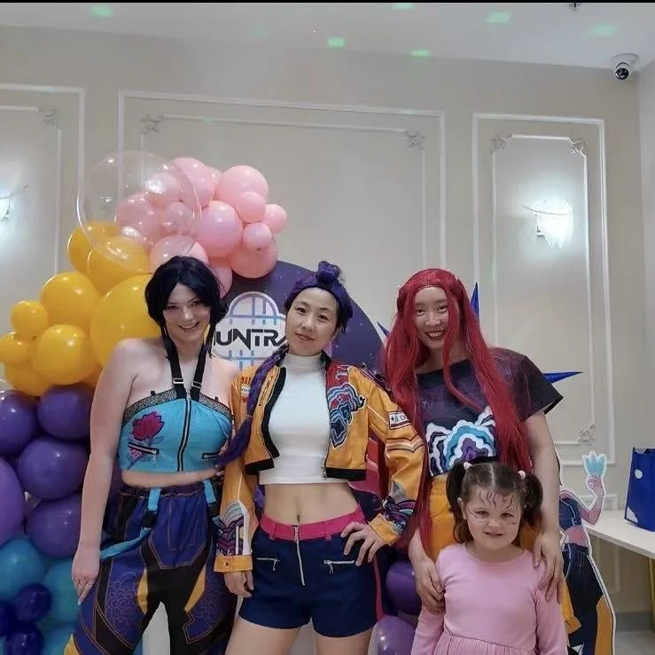 A three-tiered serving tray with assorted pastries, sandwiches, and desserts for afternoon tea.