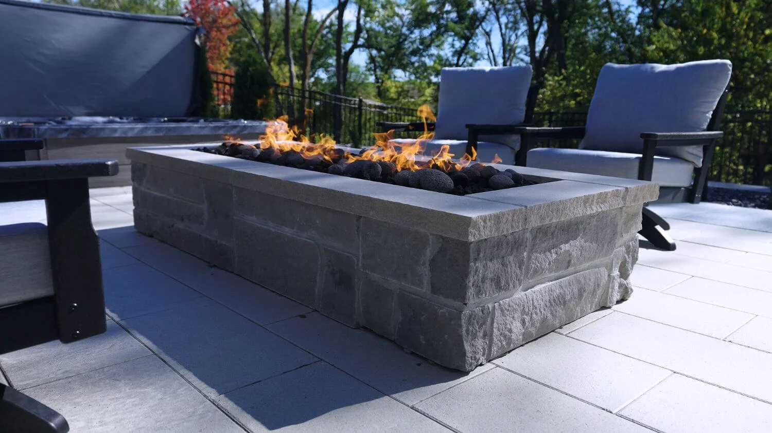 fire feature in Omaha, NE paired with a custom pool for evening outdoor gatherings