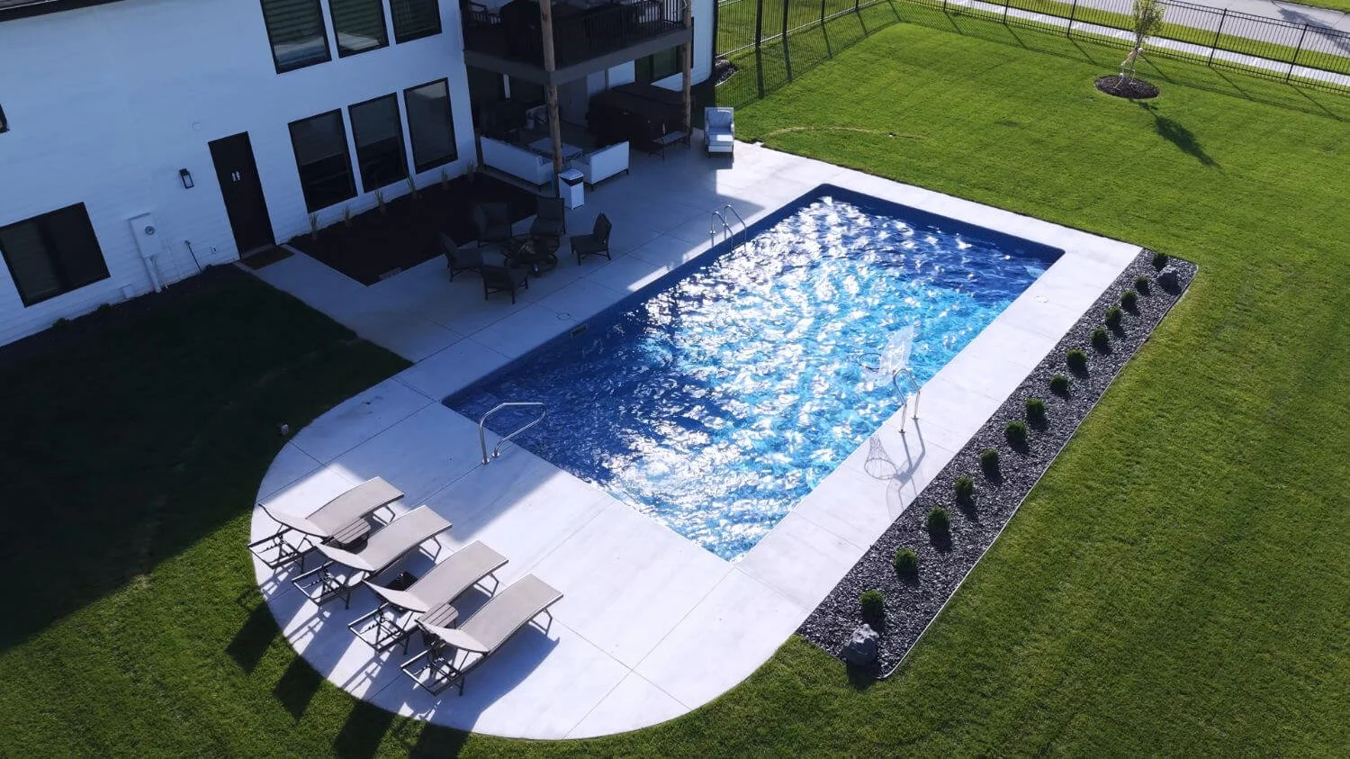 custom pool and patio in Omaha, NE with integrated patio space designed for hosting and leisure