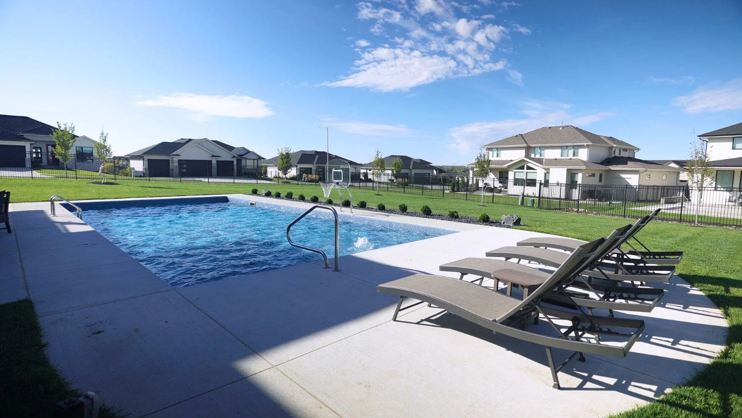 custom pool and patio Omaha, NE highlighting a refined backyard environment for at-home entertaining