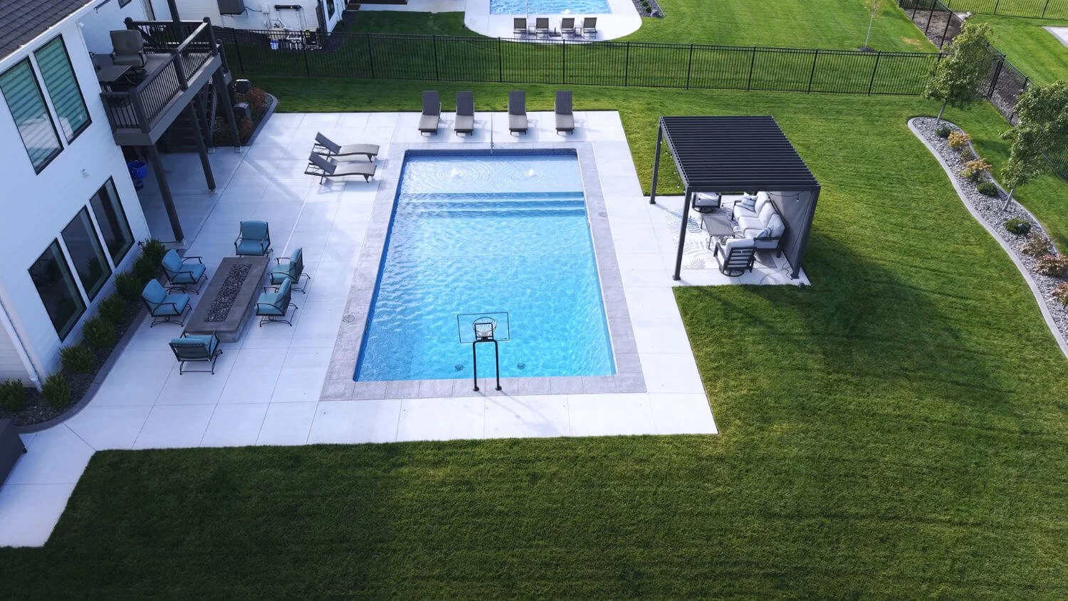 custom pool and patio in Omaha, NE built to support entertaining, relaxing, and outdoor gatherings