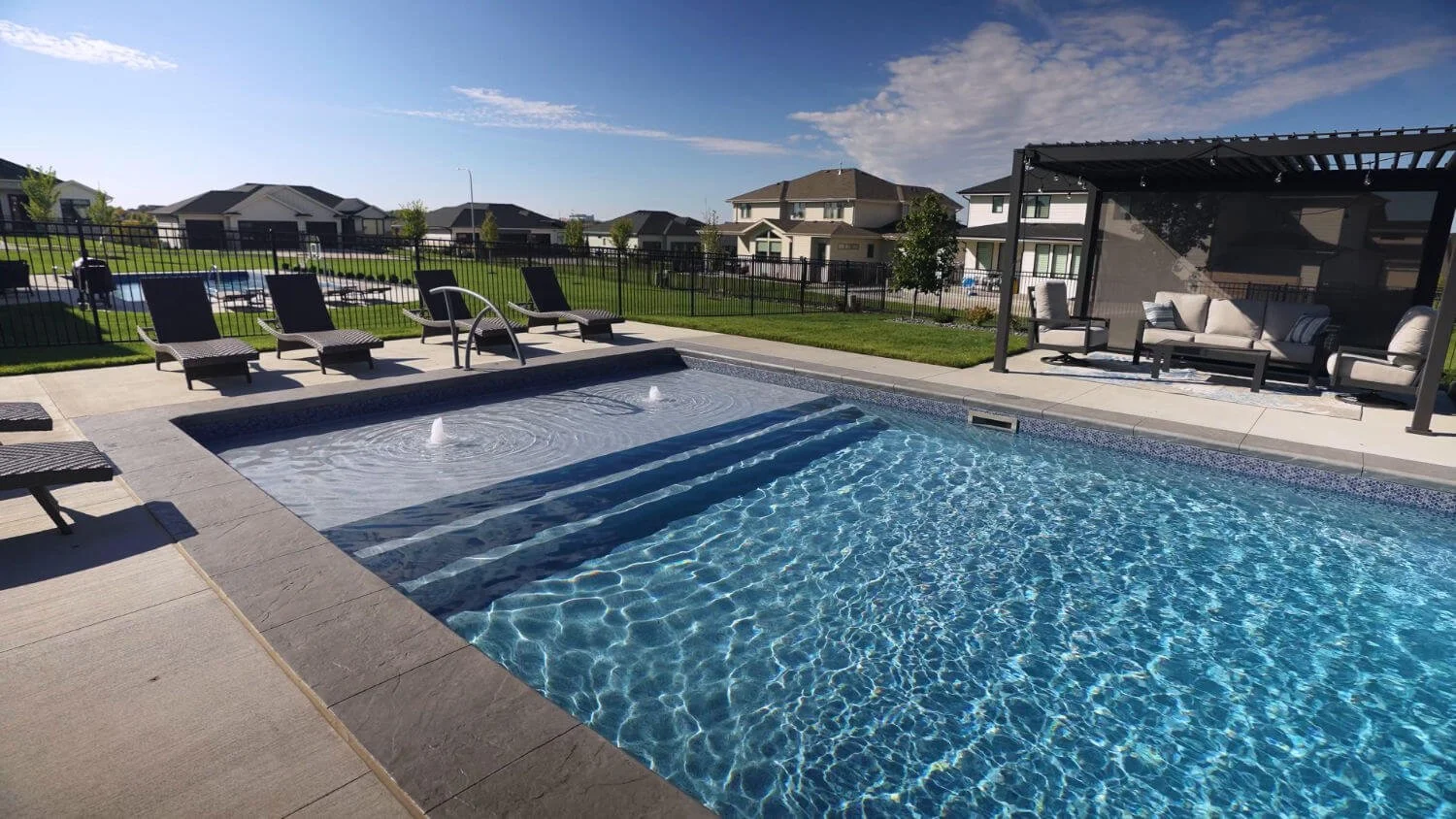 custom pool and patio project in Omaha, NE designed for backyard entertaining and relaxation 