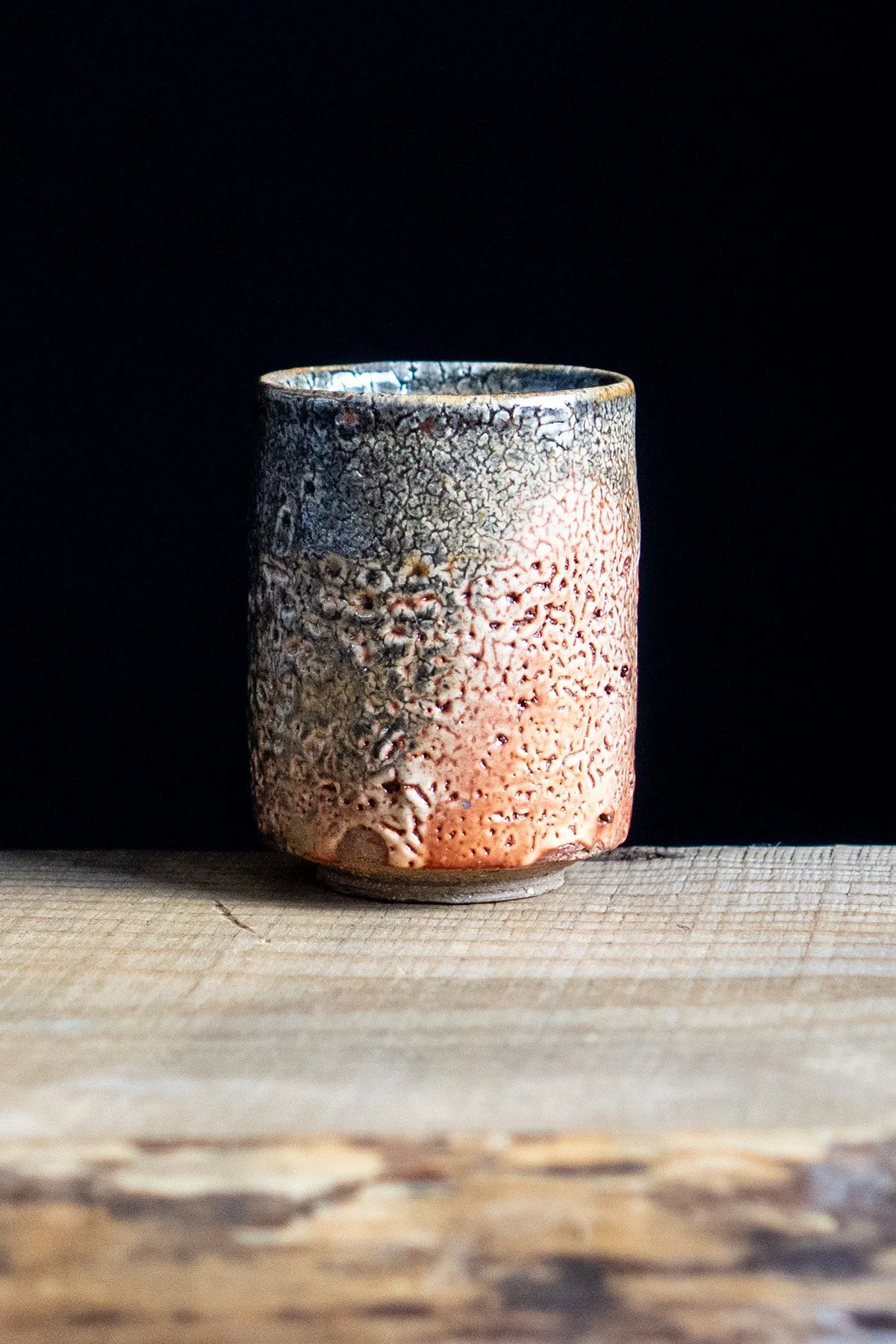 Yunomi cup with Shino glaze featuring crackled textures and soft atmospheric surfaces.