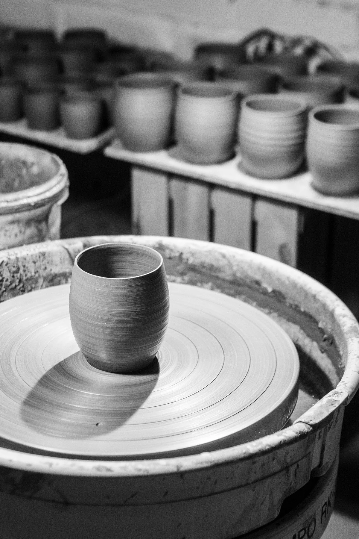 Interior of a ceramic studio focused on handmade teaware, slow process and atmospheric firing.