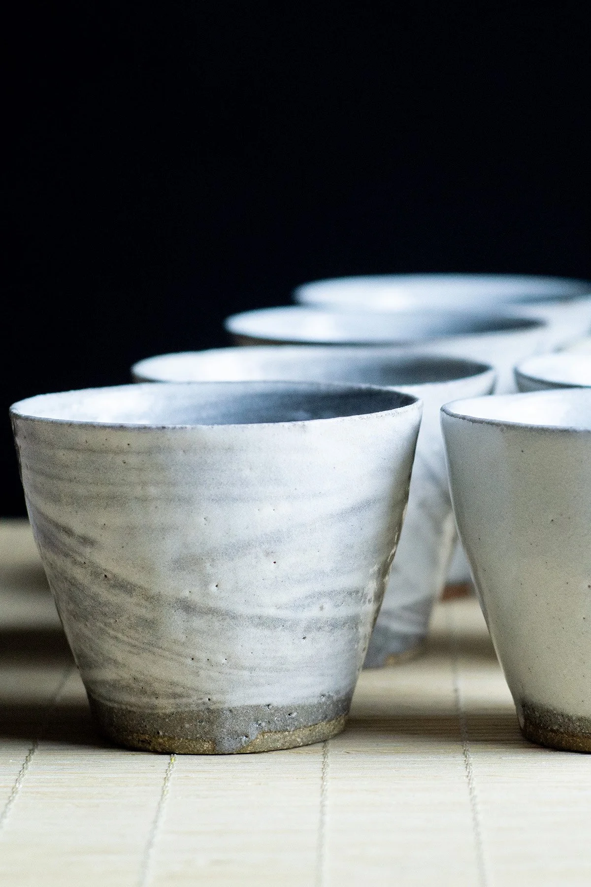 Ash glazed ceramic gongfu cups made for daily tea rituals, featuring soft textures and natural wood ash surfaces.
