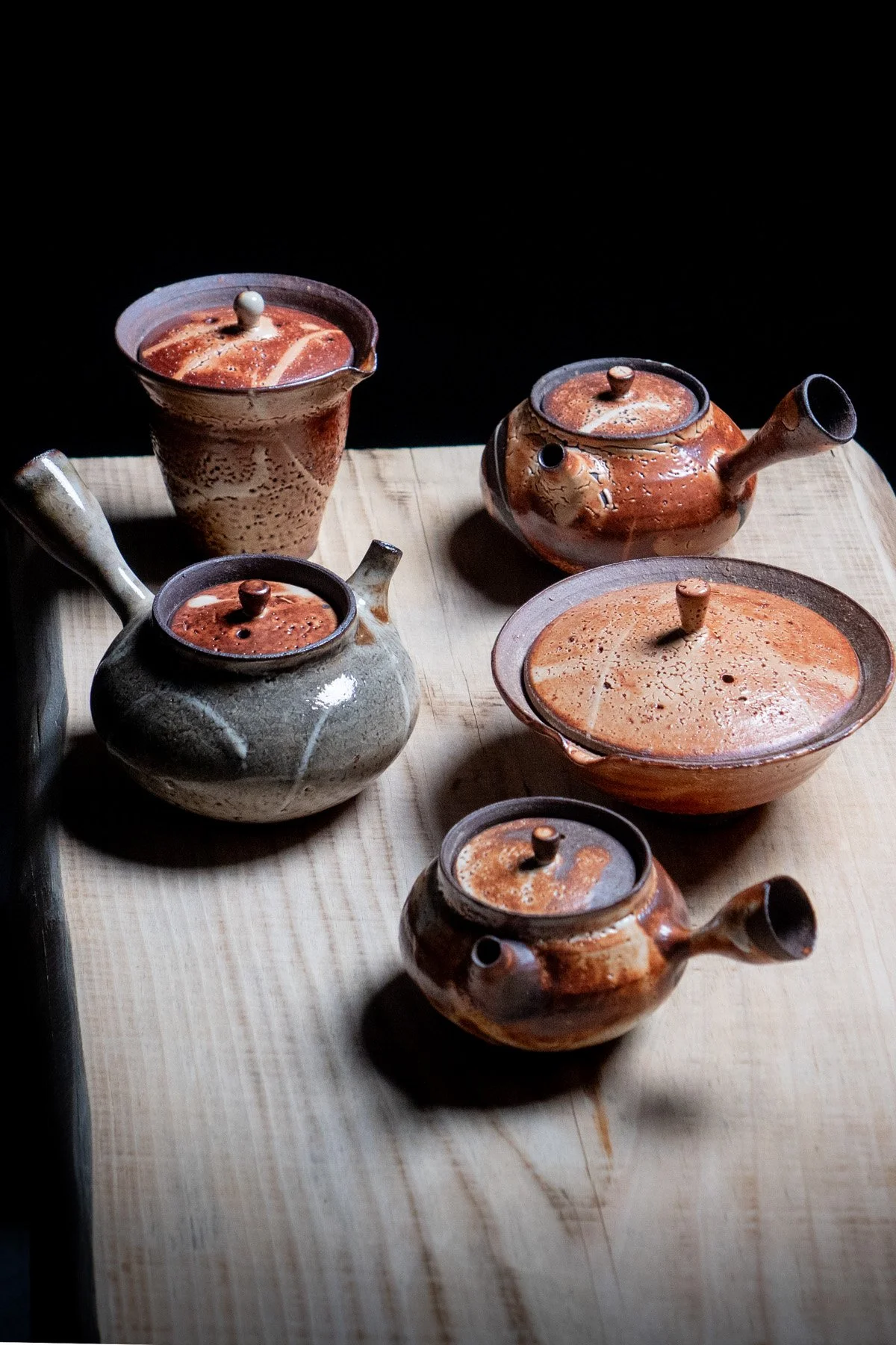 Handmade teaware with Shino glaze featuring crackled textures and soft atmospheric surfaces.