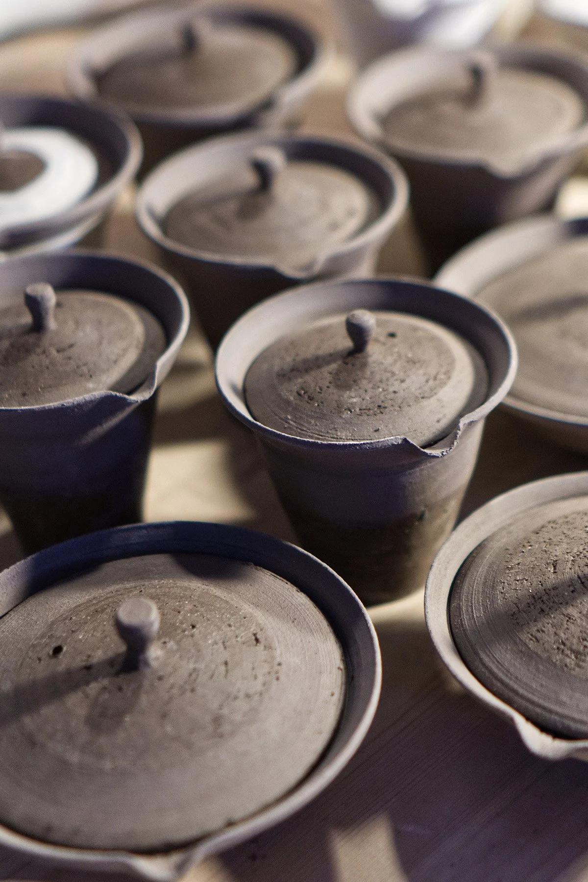 Handmaking ceramic shiboridashi teapots on the wheel as part of a slow pottery making process.