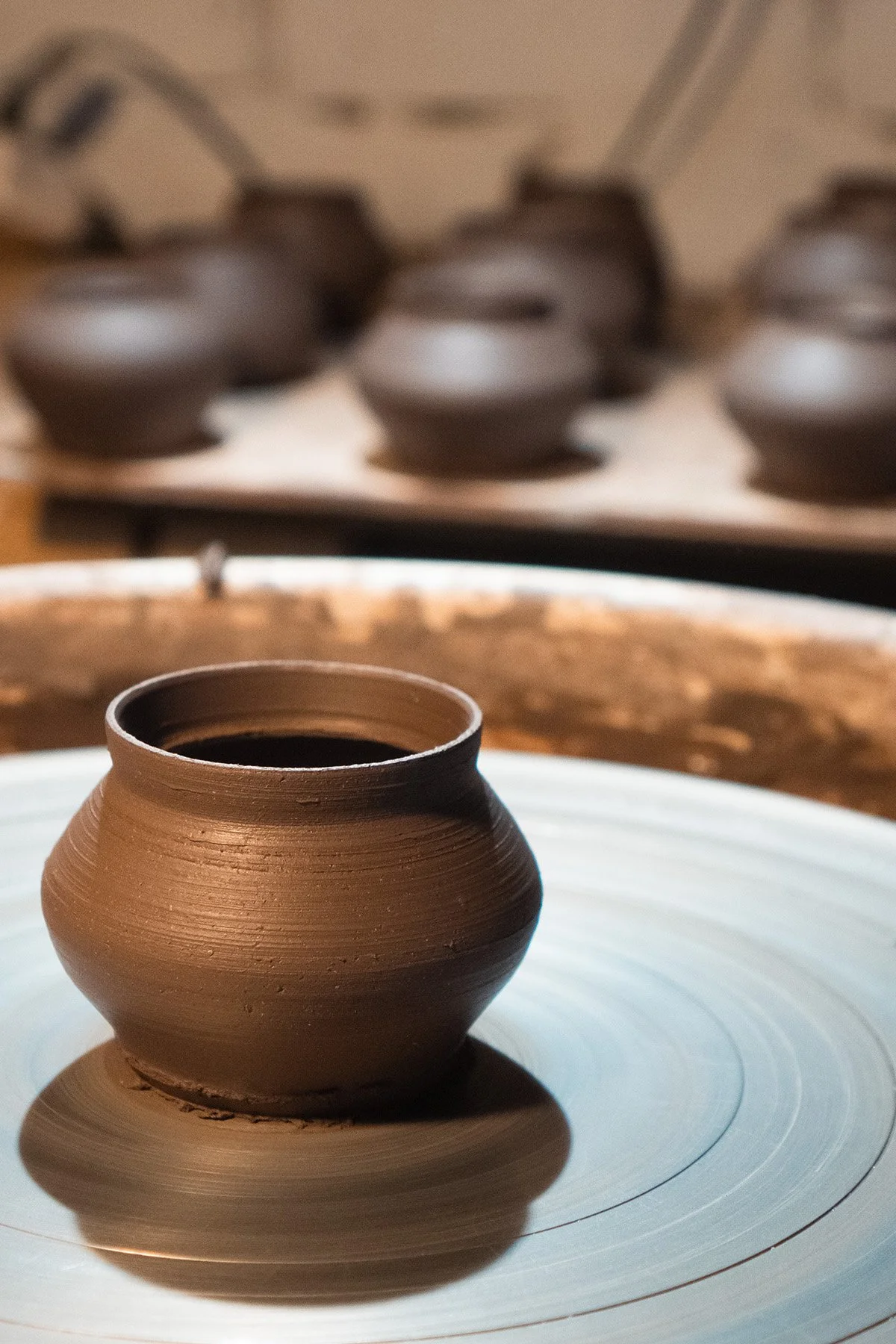 Handmaking ceramic kyusu teapots on the wheel as part of a slow pottery making process.