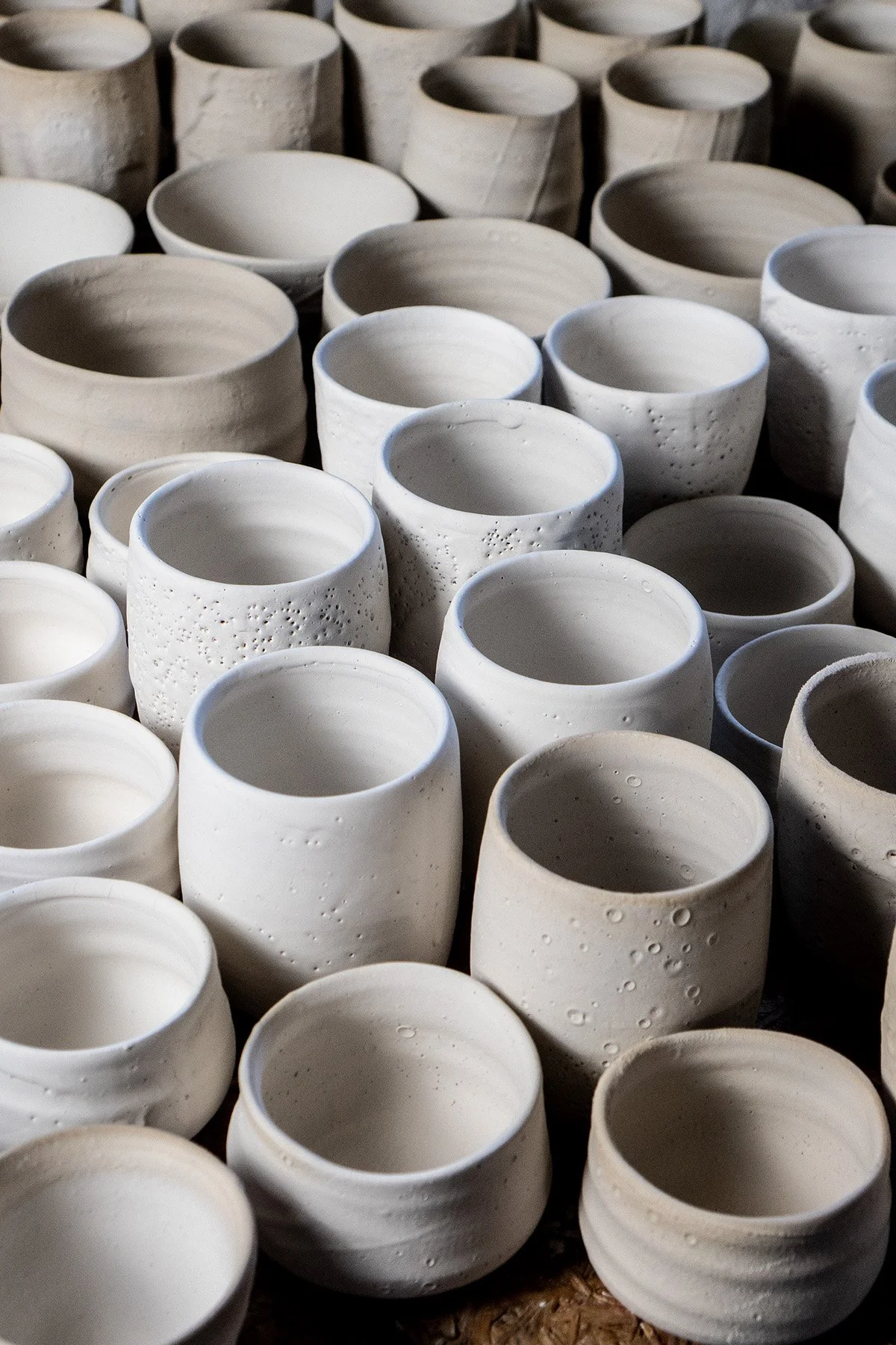 Applying Shino glaze by hand before firing in a soda and reduction atmosphere kiln.