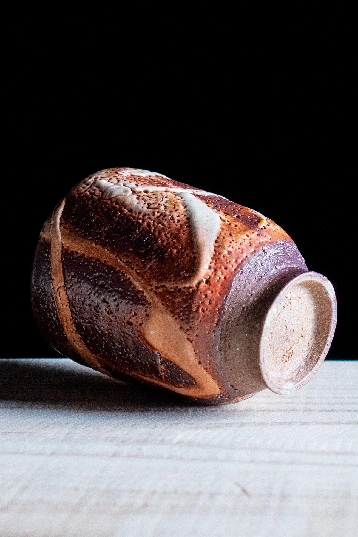 Handmade yunomi cup with Shino glaze featuring crackled textures and soft atmospheric surfaces.