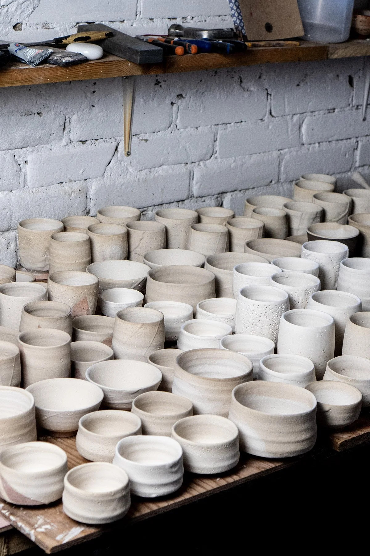 Drying pots glazed with Shino waiting to be pack into a soda kiln