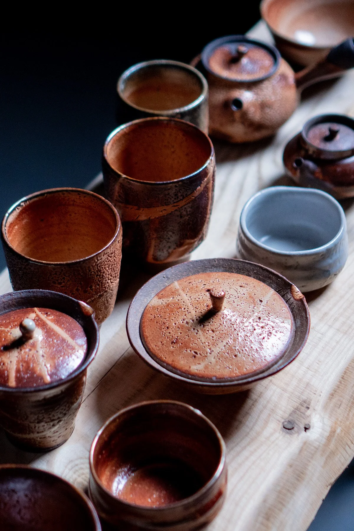 Handmade soda fired Shino teaware with rich crackled surfaces and natural variation created during atmospheric kiln firing.