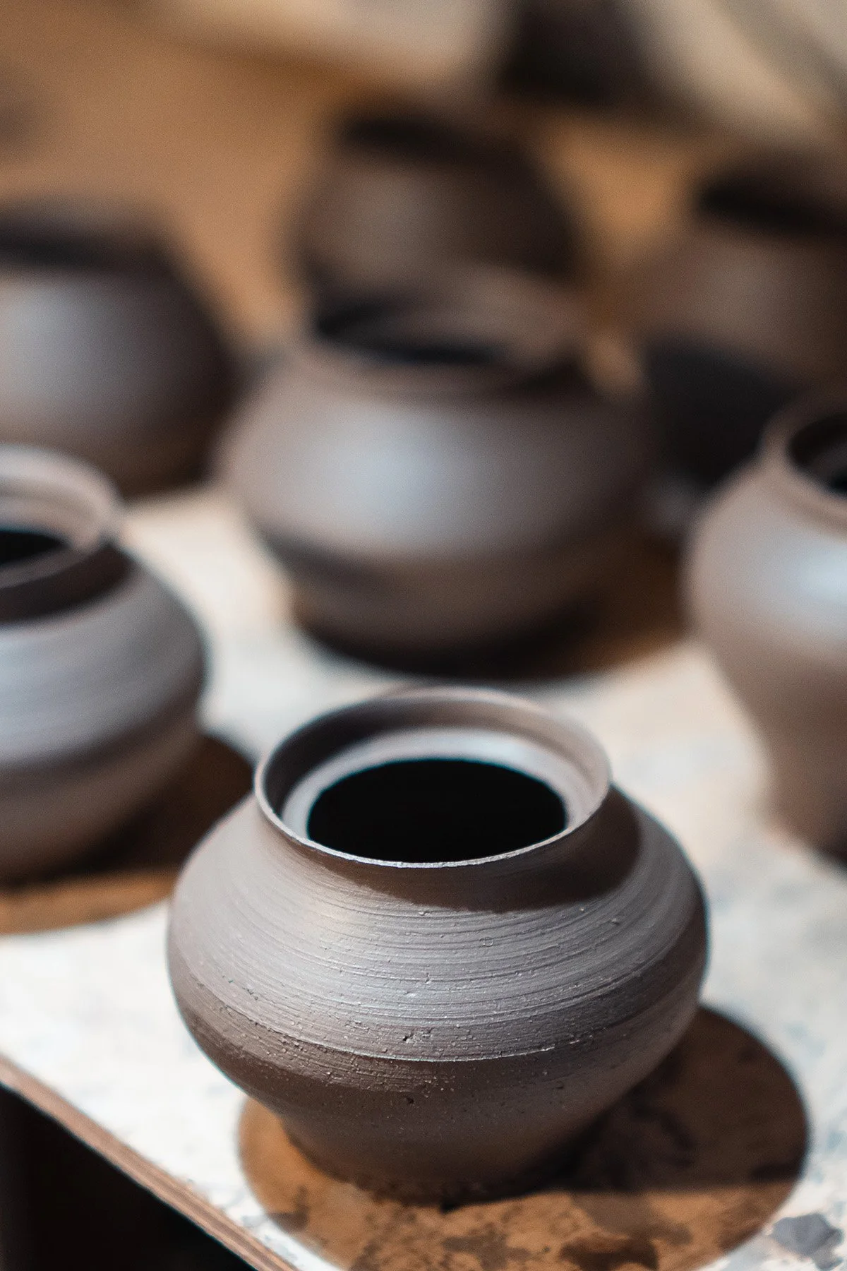 Handmaking ceramic kyusu teapots on the wheel as part of a slow pottery making process.