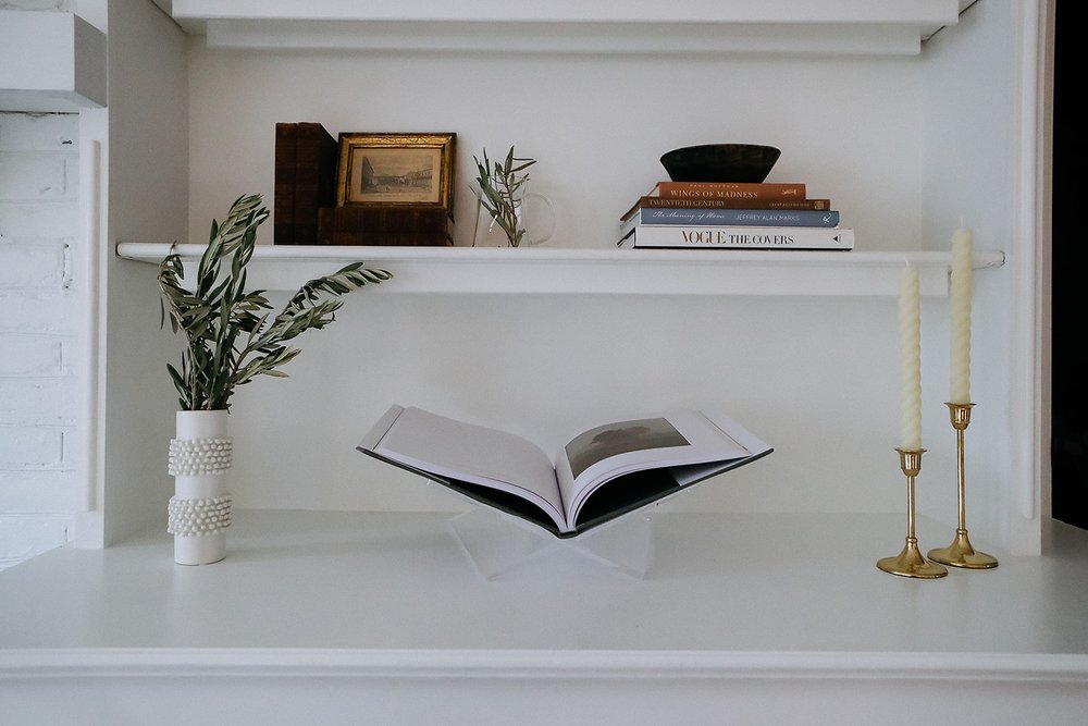 books and other decor shown on shelf decoratively