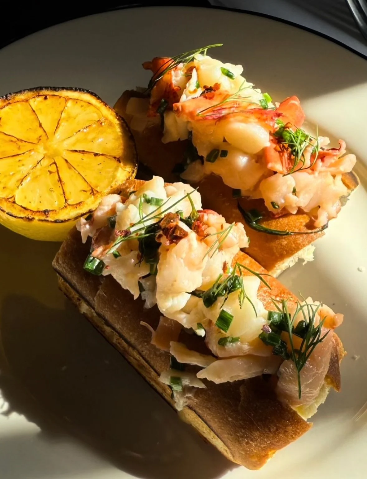 For all the lobster lovers! Our Lobster &amp; Crab Roll app with gremolata on a brioche bun. ($32) And our popular favorite: charcoal roasted whole Maine lobster, with spiced sweet corn, fingerling potatoes, Aleppo butter, preserved lemon gremolata (
