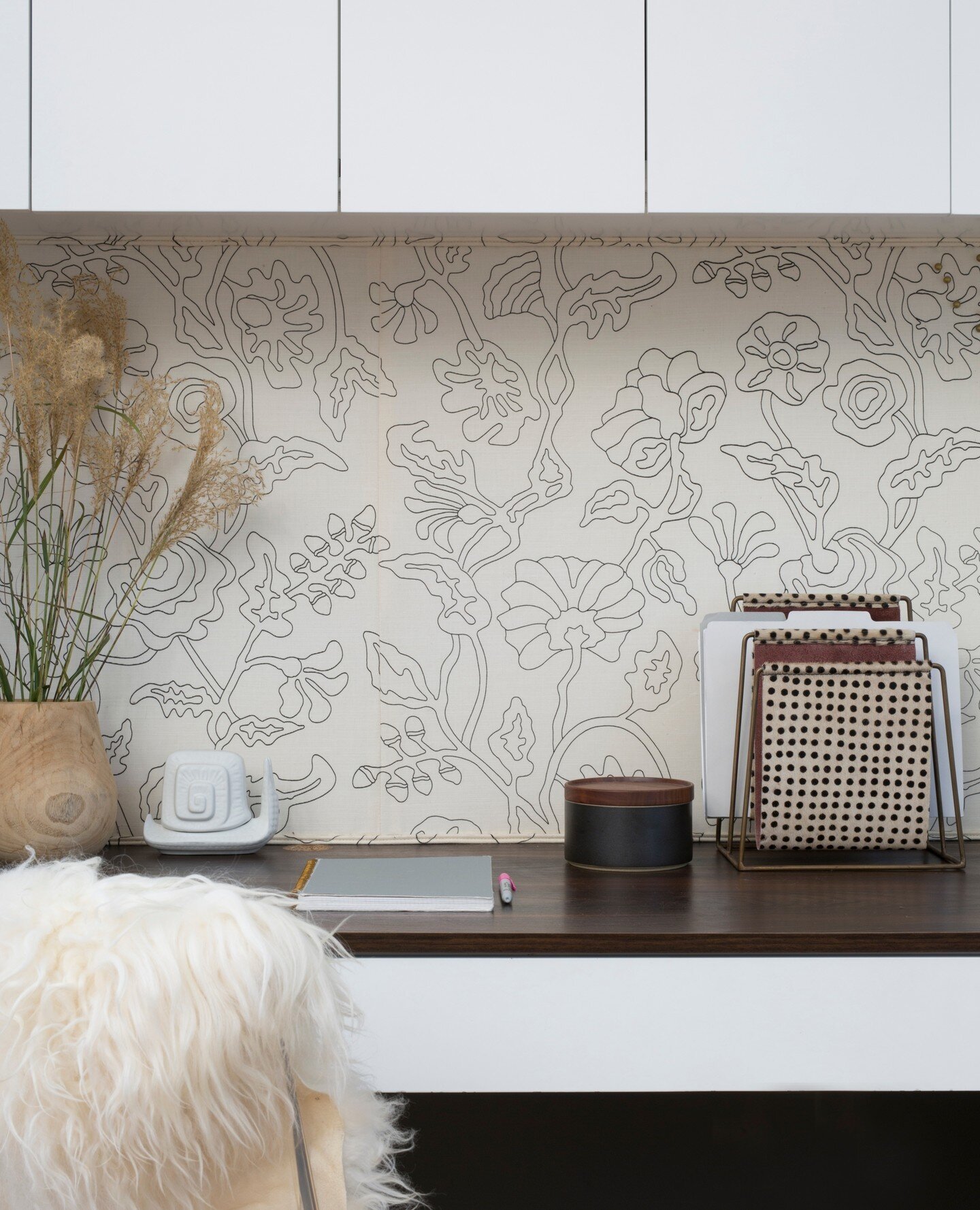 One of my favorite things to do with fabric is use it to upholster walls. Our client wanted to create a functional home office with a tackable wall inside a little niche in her kitchen. Nobody wanted to see a cork board in the middle of the all white