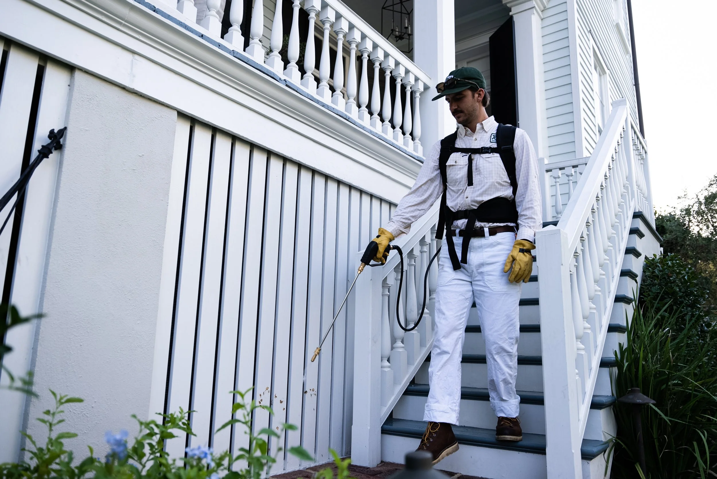 Service professional spraying a home