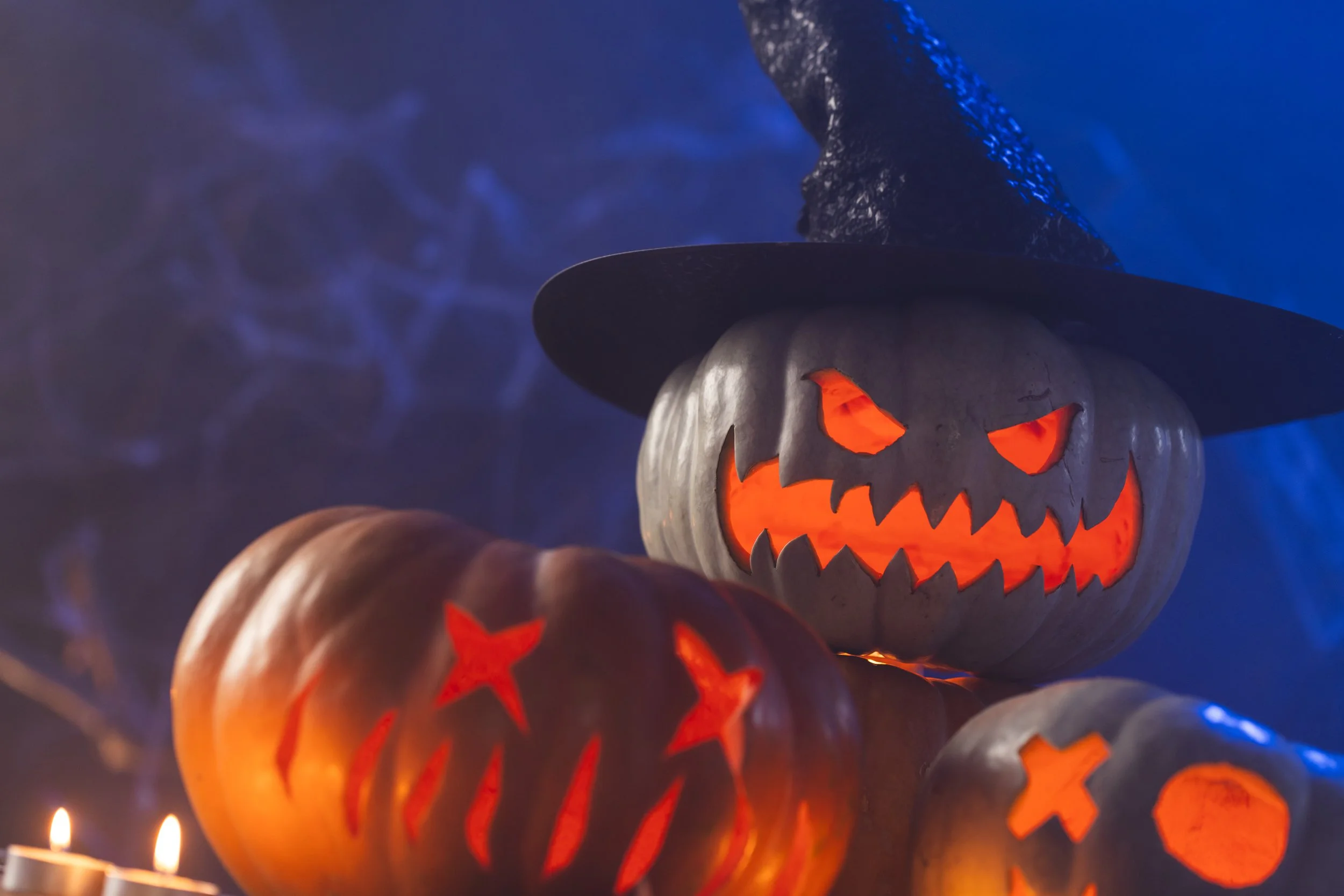 three-carved-pumpkins-and-candles-with-copy-space-2025-04-03-16-06-18-utc.jpg
