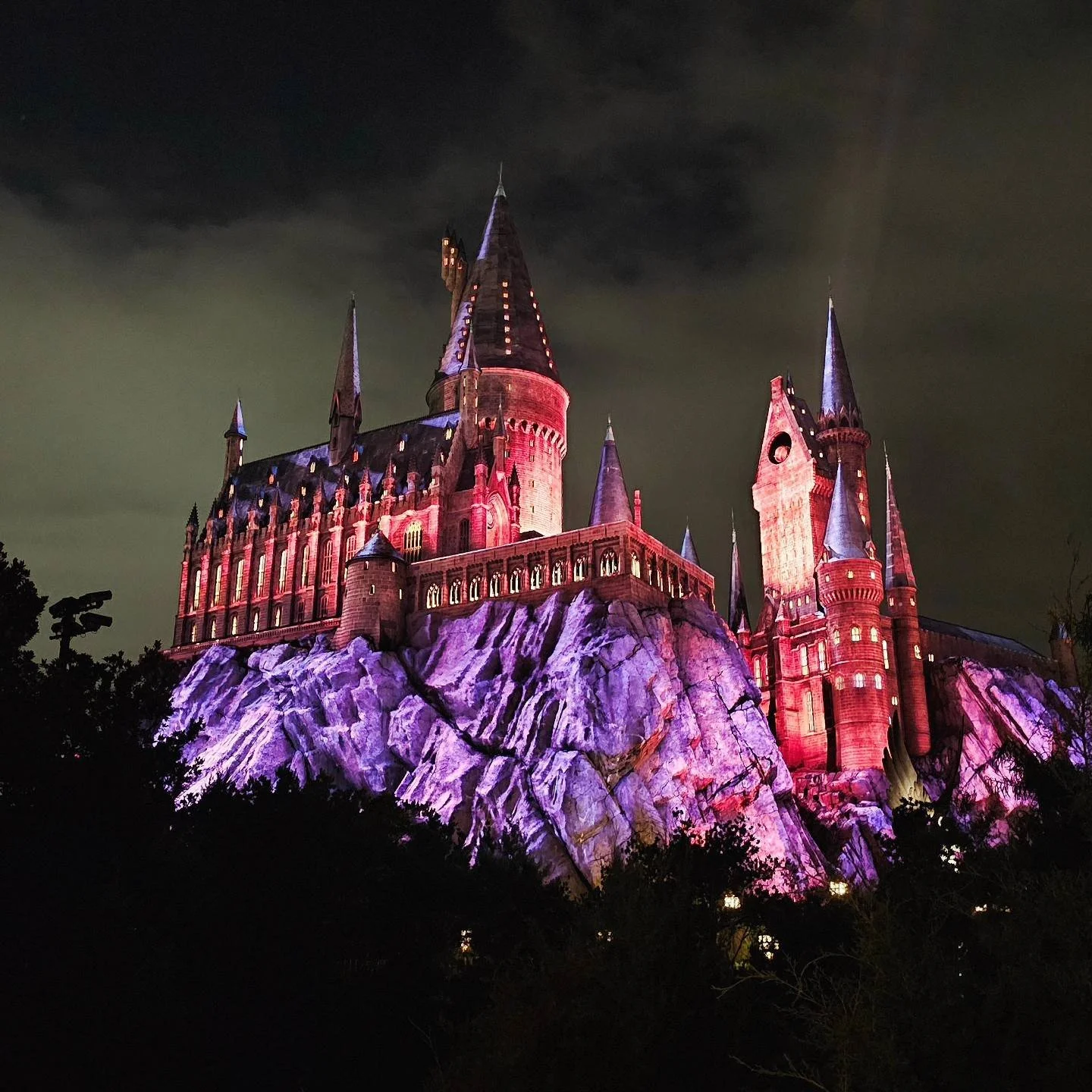 Hogwarts Castle at Islands of Adventure in Universal Orlando Resort in Orlando, FL at night, beautifully lit up with lights.