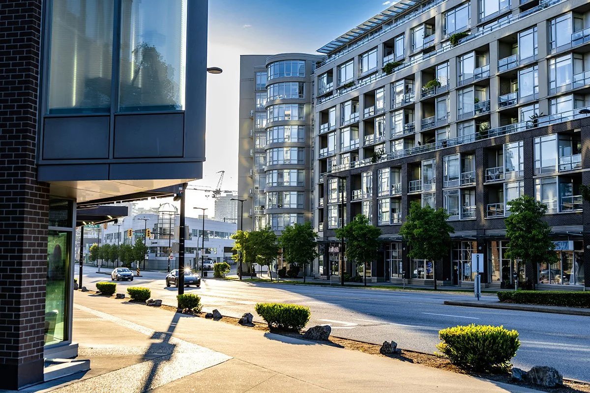view of large apartment building from city street to show example of REIT