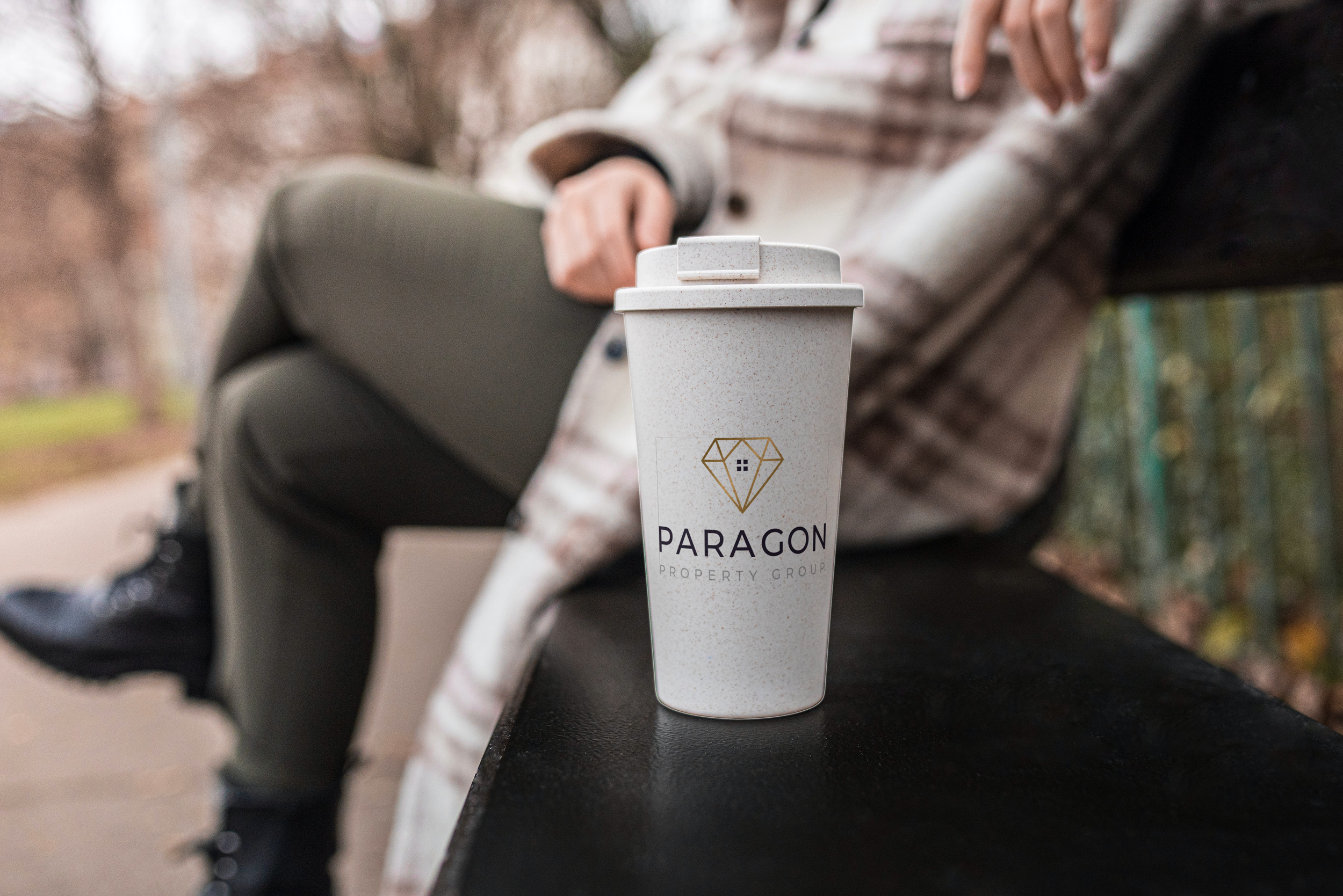 Cup on the bench near the woman_PPG-001 Paragon Logo 2-white-background (1).png