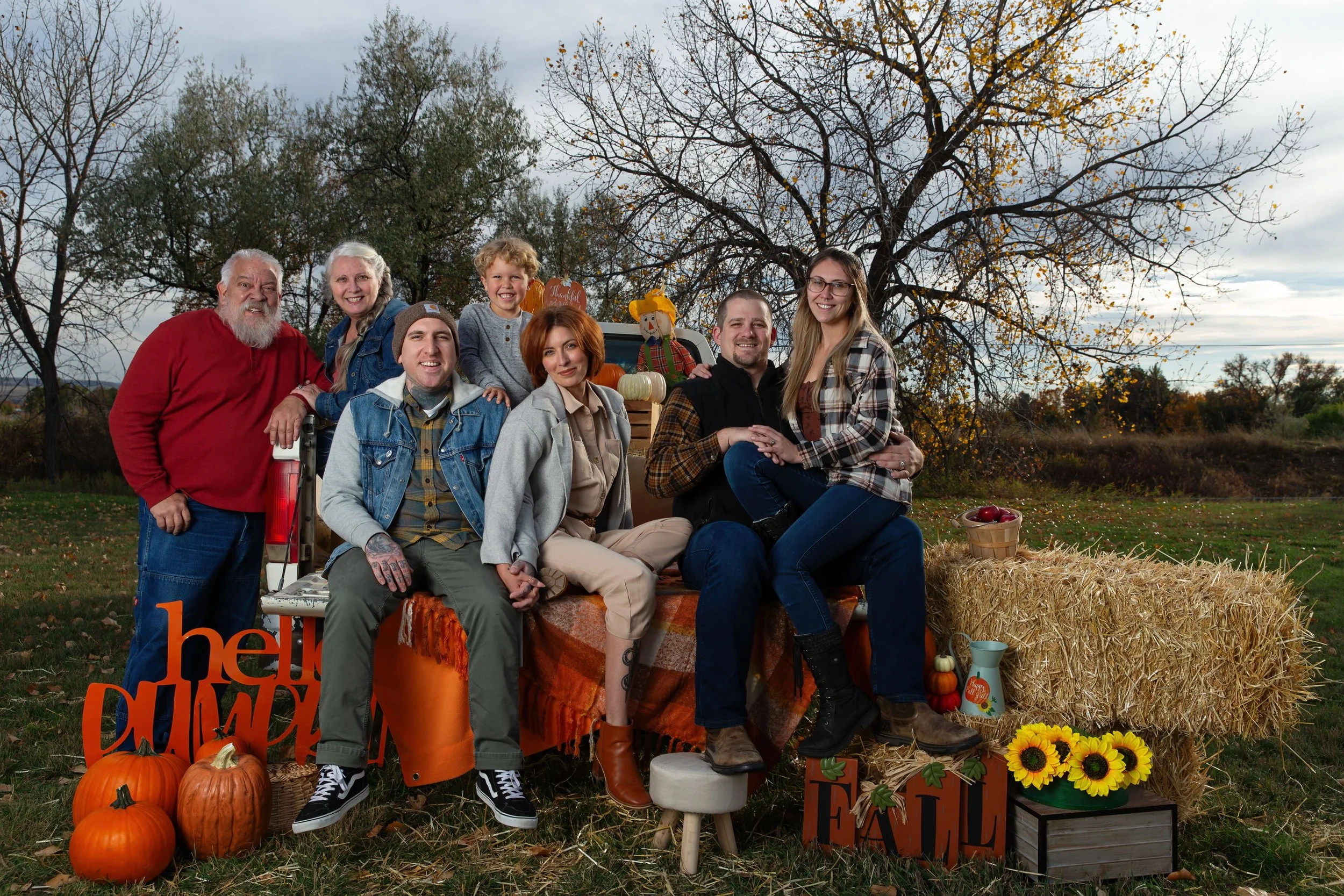 Generational family Autum truck mini session with pumpkins and other Fall decor and hay bales in Laurel MT