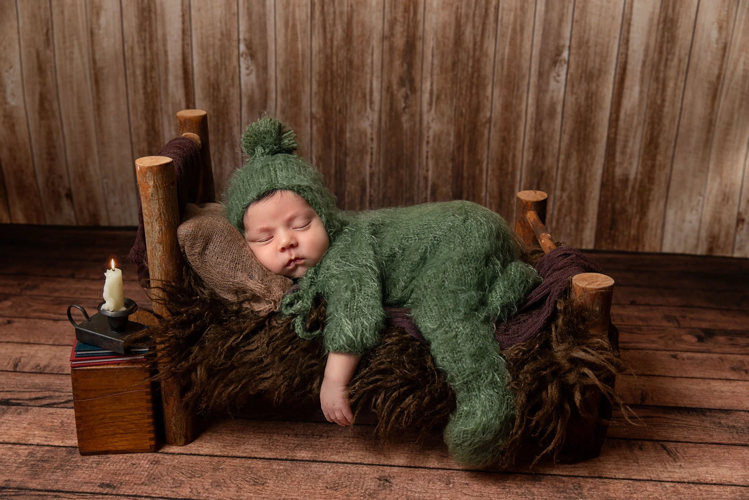 photo of newborn baby on log bed in Laurel, MT