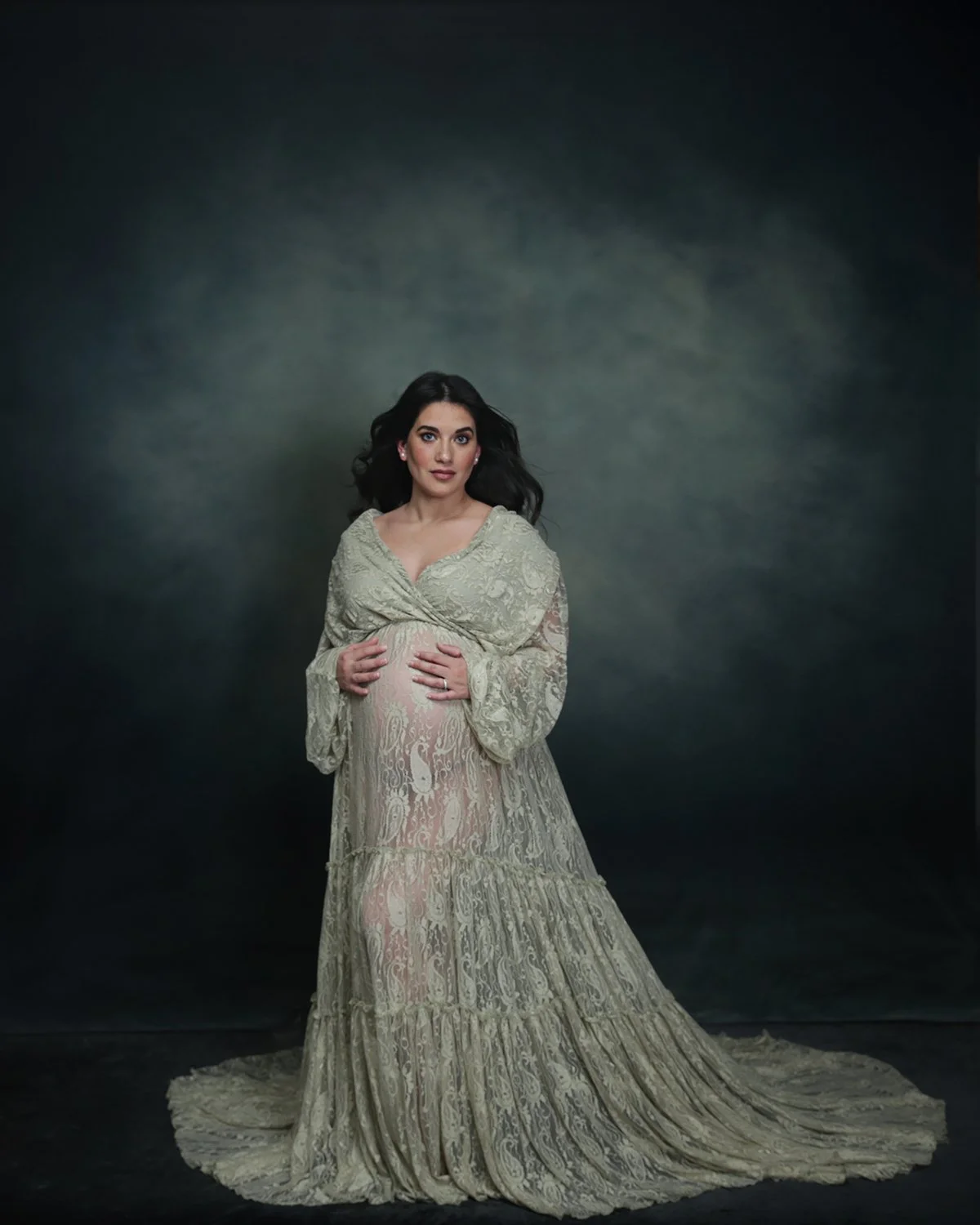 Pregnant woman holding her stomach for maternity photo