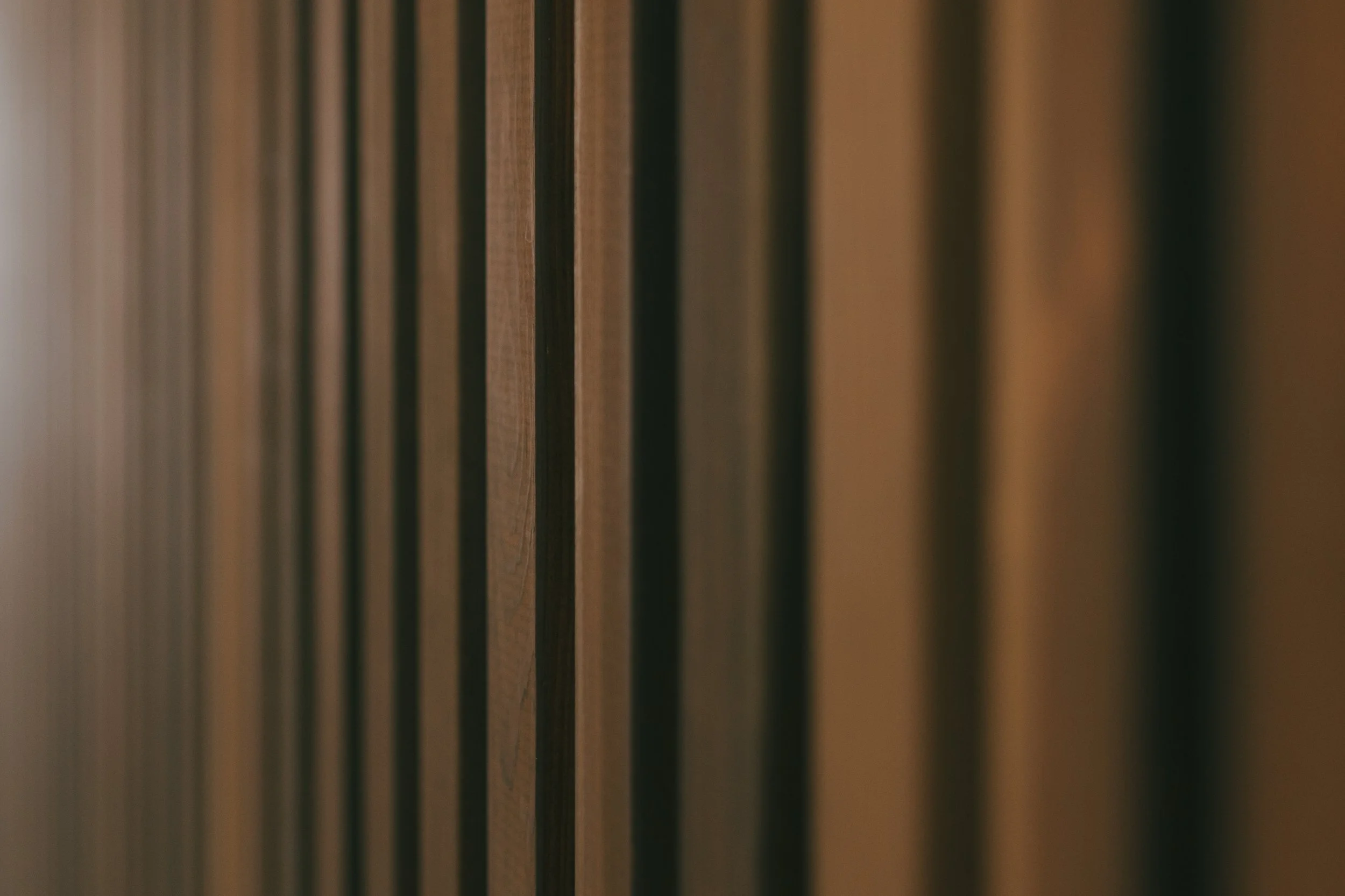 Close-up of wooden slats or panels, arranged vertically.