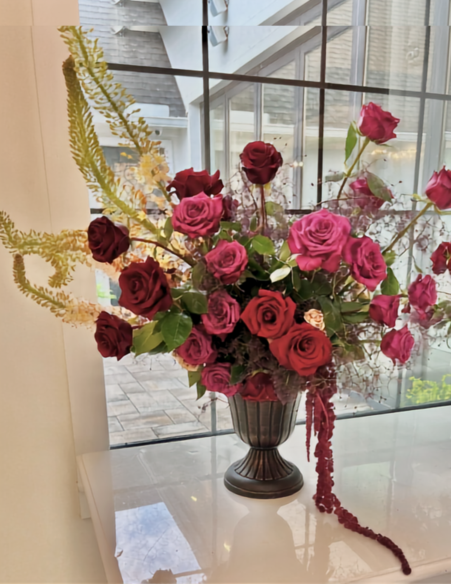 Large urn of roses for holiday parties.