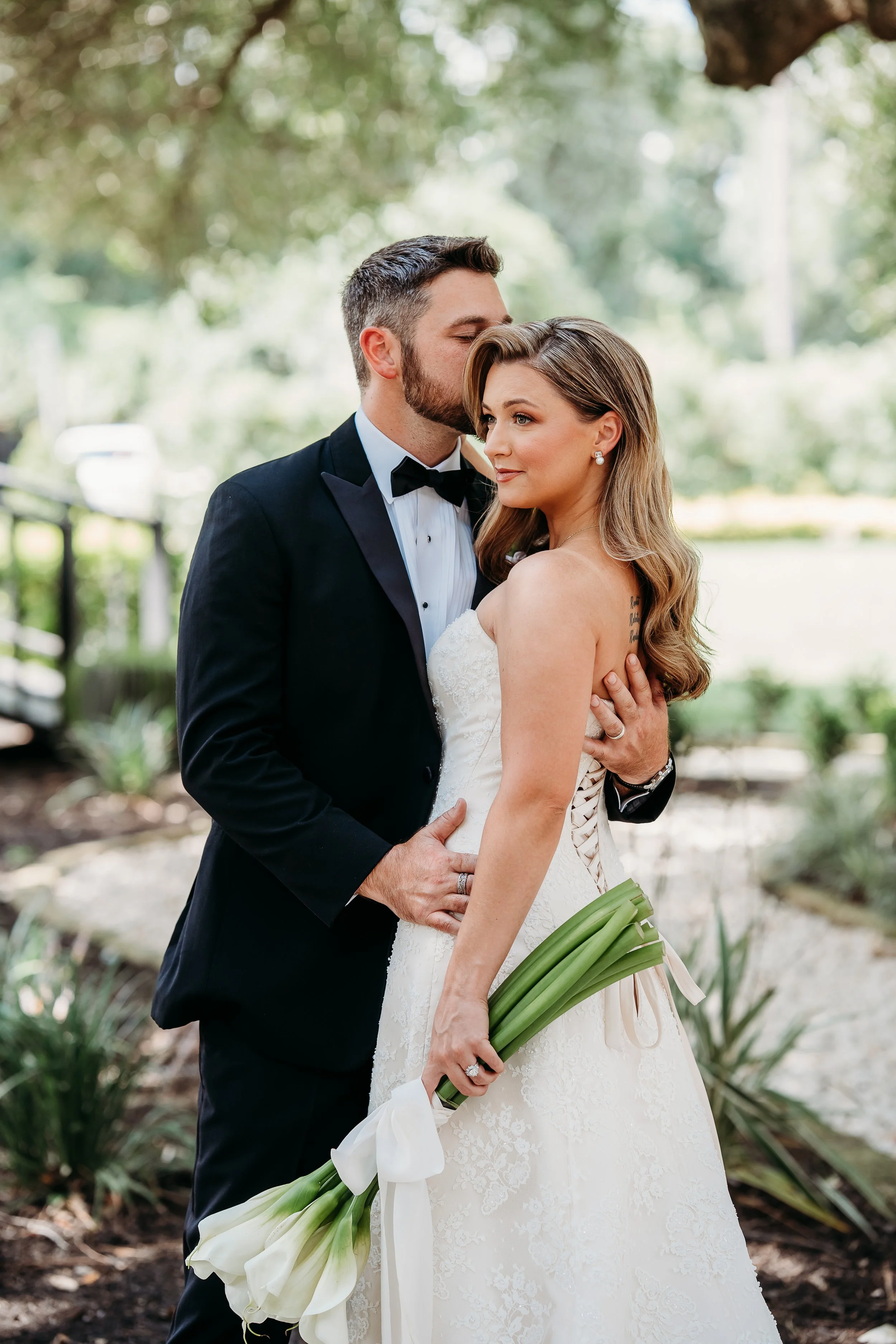 Couple and bride is holding calla lily bouquet.