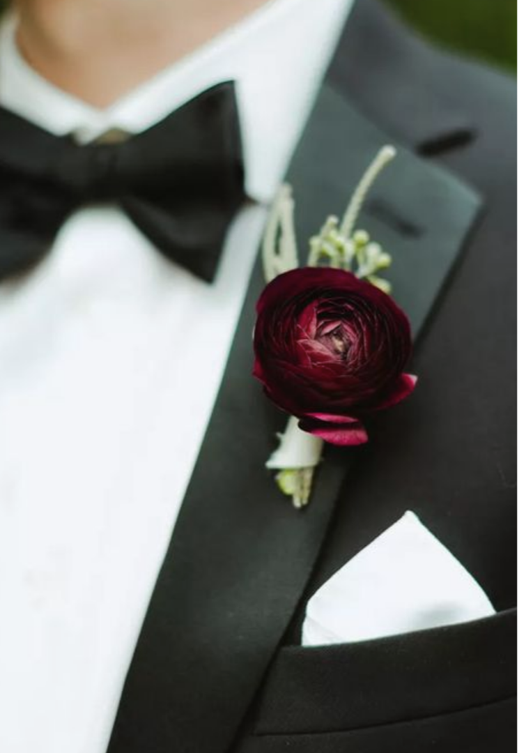Groom wearing a burgundy boutonniere..