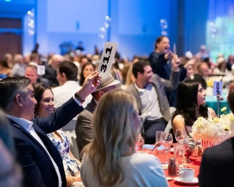 Elegant floral arrangements designed for a gala event, demonstrating versatility across color palettes and corporate environments.