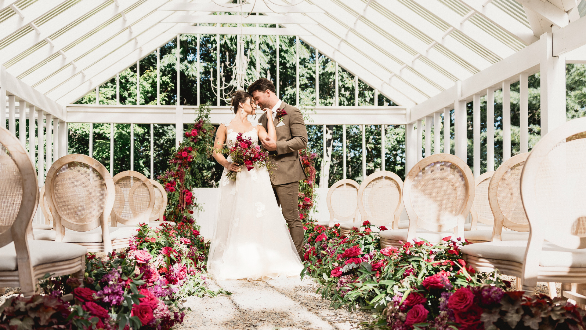 A couple standing in a luxury wedding ceremony designed by Houston luxury wedding designer, Fashionable Florist.