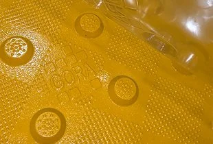Close-up of the GORA 24x24" safety yellow fiberglass tactile plate.