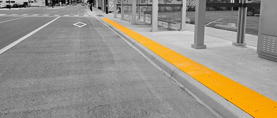 Dundas and Burbrook new transit line bus shelter with GORA 24x24" safety yellow fiberglass tactile plates spanning in front of the bus shelter.