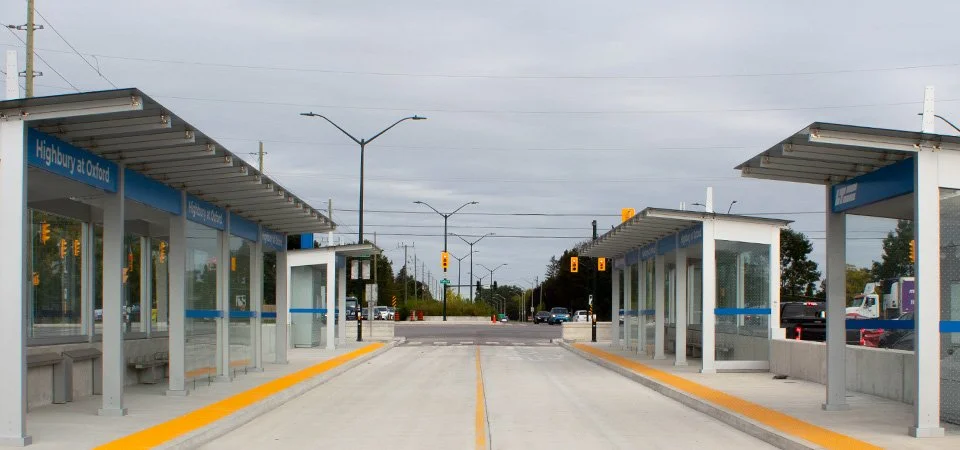 Highbury and Oxford new transit line bus shelter with GORA 24x24" safety yellow fiberglass tactile plates spanning the entire side walk on each side of the bus shelter.