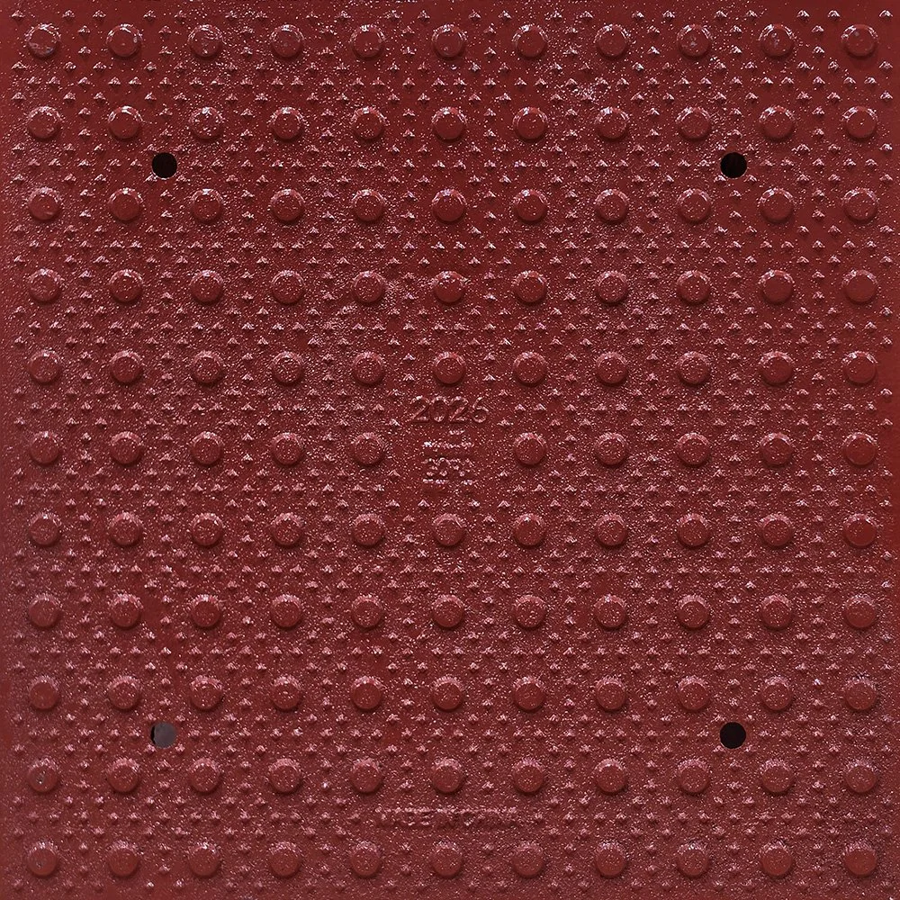 Product close-up of the GORA 24x24" (610x610mm) brick red steel tactile plate.