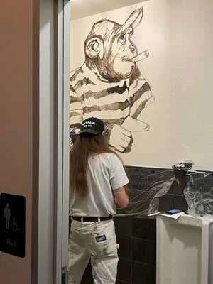Jon Mckenzie, Varsity Walls custom murals. unique art. fun bathrooms, clean restrooms, gender neutral bathrooms, private restrooms. funky decor. oversized murals. Aggieland Art Trail. Local artists.