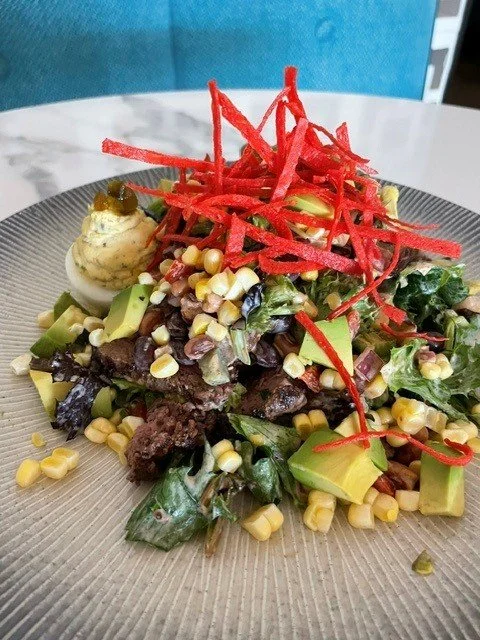 Seasonal Cattlemen steak salad. Fresh ingredients. Sirloin, beans, corn, tomato, avocado, tortilla strips, and chipotle ranch. served with a deviled egg, stuffed egg. lunch specials. southwest salad. lunch break. fresh greens.
