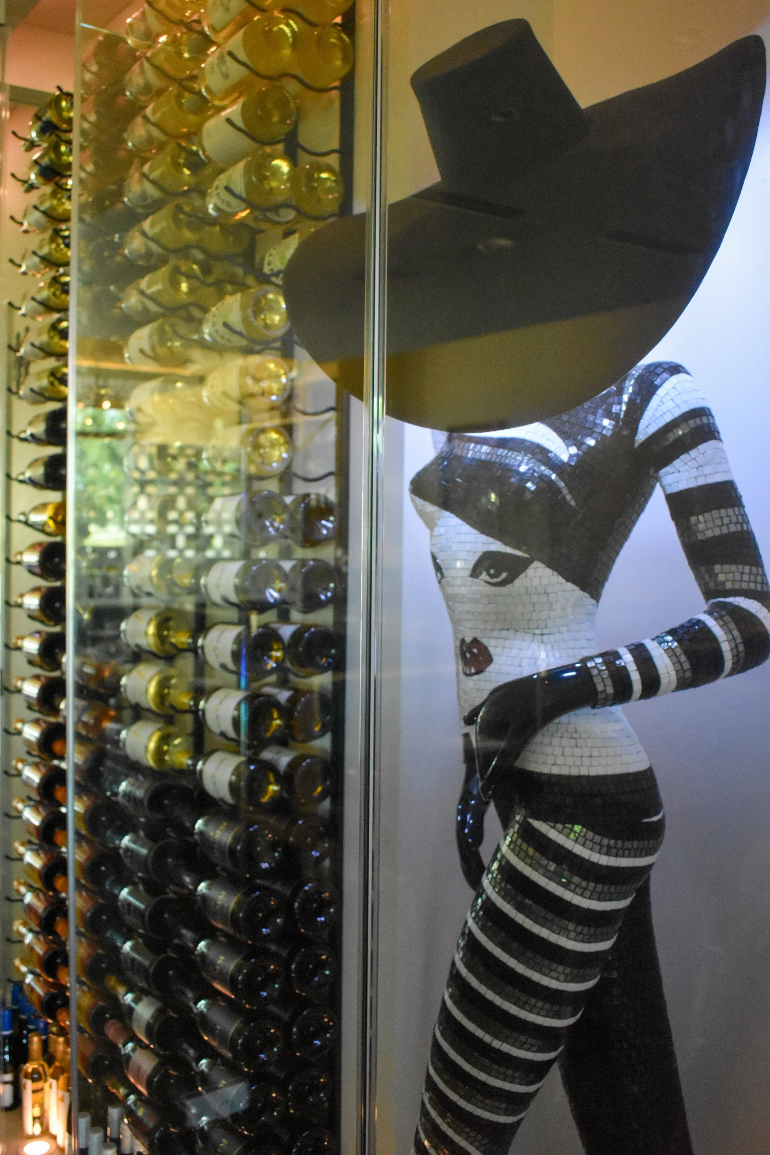 Italian tiled maniquin art piece. Unique display. large worldly wine selection. interesting wines. Wines by the glass, half bottle wines, and full bottles of wine. 375ml and 750ml formatted selections of wine.