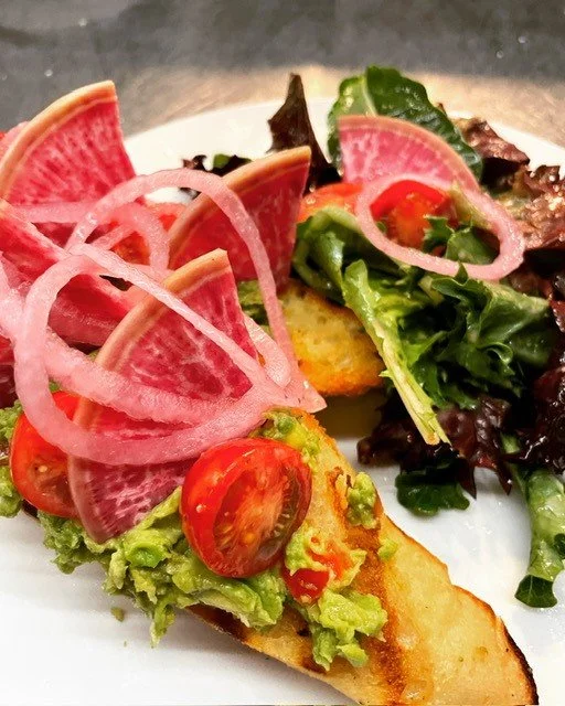 Fresh made avocado toast for weekend brunch. Made to order. Side salad with housemade fig vinaigrette. Healthy breakfast. Vegan and vegetarian options. Clean ingredients. French bread. fresh produce.
